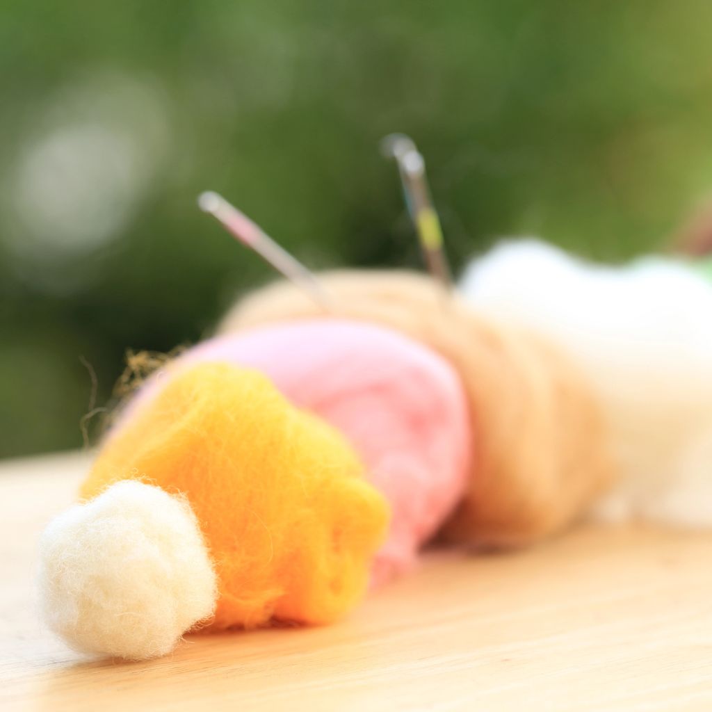 Several piles of roving to be used for needle felting