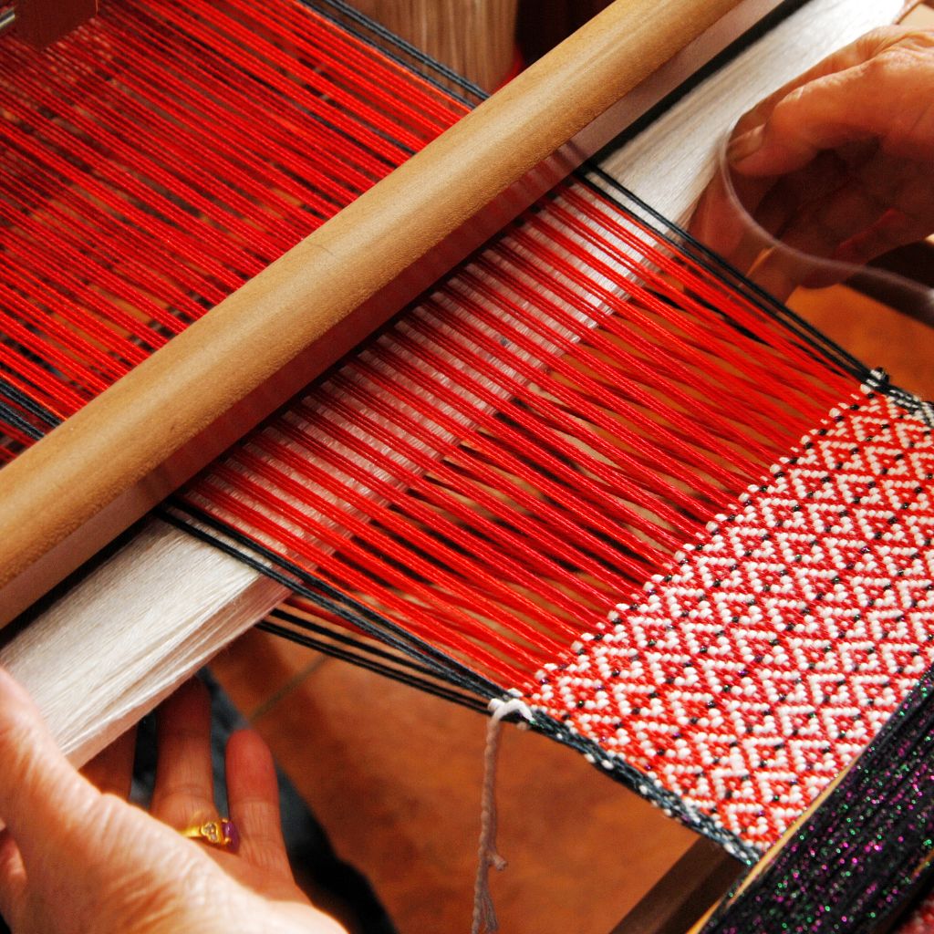 Loom with red and white woven design